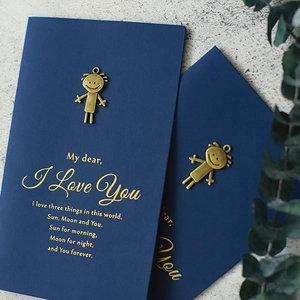 Navy blue vintage greeting card with brass metal charm and gold foil text on stone