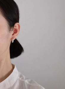 Detail view of retro S925 sterling silver hoop earring worn on model for modern minimal look
