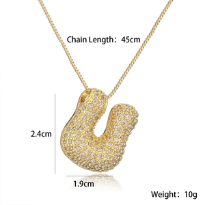 Macro view of gold plated letter U pendant with iced-out crystals and box chain dimensions