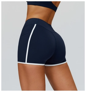 Detail of high-waisted navy yoga shorts featuring white contrast trim and stretchy fabric