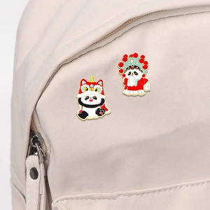 Chinese panda enamel pin featuring lion dance and Peking Opera styles on canvas backpack
