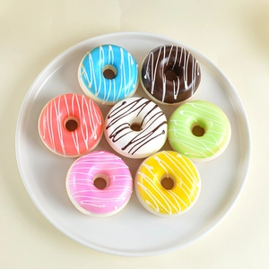 Set of 7 colorful PU faux donuts in assorted icing colors on a white circular tray