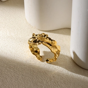 Detail of gold snake-like irregular curved ring with textured molten lava metal surface