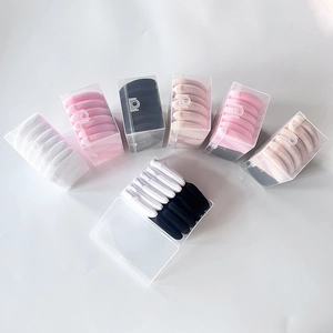 Detailed view of assorted multi-color makeup sponges in a clear rectangular plastic case