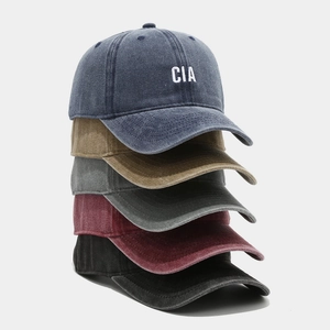 Detailed stack of vintage washed cotton baseball caps showing CIA embroidery and 5 colors