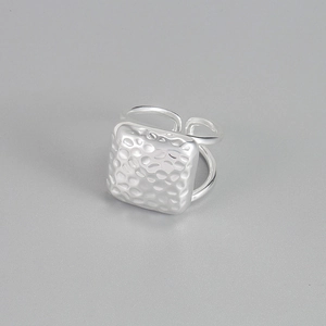 Detailed view of 925 sterling silver square ring with a unique hammered texture finish
