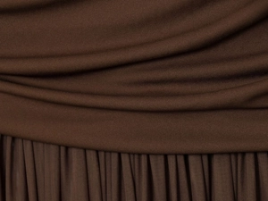 Macro view of dark brown mesh fabric showing vertical pleats and horizontal ruching details