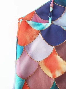Detail of mermaid scale print dress with thin shoulder straps and side zipper closure