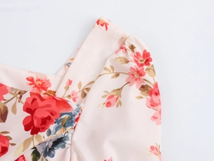 Detail of French floral print dress featuring cowl neck design and soft pleated fabric
