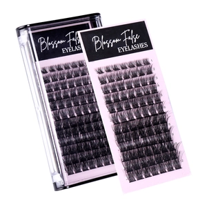 Blossom false eyelashes two-pack featuring dense multi-row clusters on pink cards