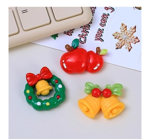 Detailed view of DIY Christmas resin charms featuring apple, wreath, and bell designs
