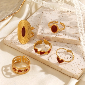 Five-piece set of gold stainless steel rings with red heart and bow enamel details