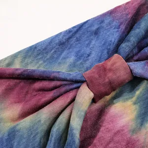 Detail view of tie-dye knit yoga headband featuring purple and pink twisted knot texture