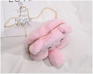 Detail of pink plush bear bag with golden metal chain strap and soft faux fur texture