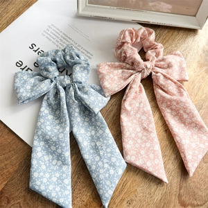 Detail of floral scrunchies with long ribbons in light blue and pink fabric