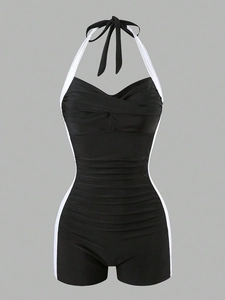 Detail of black one-piece swimsuit featuring slimming side stripes and ruched tummy control