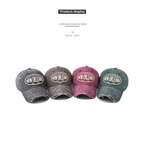 Detail showing four vintage washed cotton baseball caps with distressed brim and embroidery