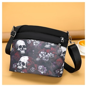 Macro view of gothic skull and floral print on durable black nylon crossbody shoulder bag