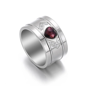 Elegant stainless steel ring featuring a heart-shaped red gemstone and side crystals