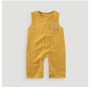 Detail of baby cotton gauze bodysuit featuring a cute brown bear embroidery patch
