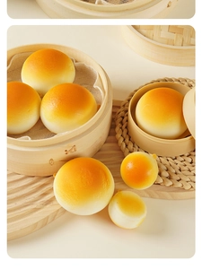 Close-up of realistic slow rebound squishy bun toys in a bamboo steamer setup