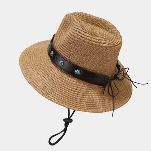 Western straw cowboy hat with leather band and turquoise studs shown from a side view