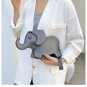 Detail shot of a cute elephant-shaped grey PU leather crossbody bag worn by a model