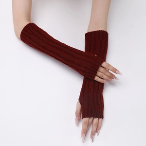 Detail showing burgundy cable knit arm warmers with fingerless design and ribbed texture