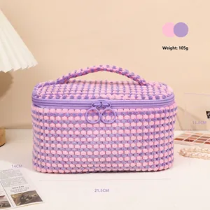 Pink checkered plush cosmetic bag with handle and double zipper closure for travel