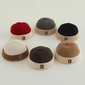 Kids vintage ribbed knit melon caps in six colors with letter C patch on neutral background