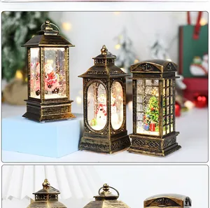 Detail of vintage Christmas snow globe lantern with Santa and warm LED glow decor