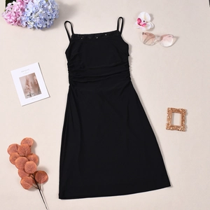 Flat lay of a black backless mini dress with sequins and elegant fashion accessories