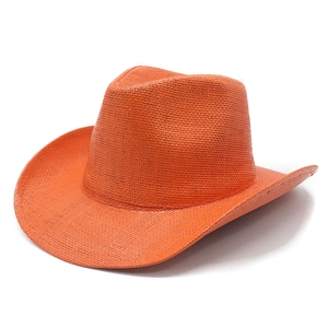 Close-up of vibrant orange woven straw cowboy hat with wide brim and textured weave