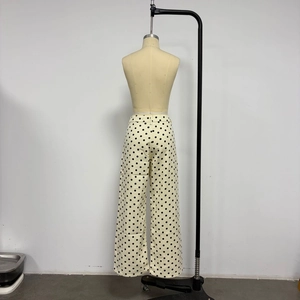 Detailed back view of high waist polka dot wide leg denim trousers on a mannequin