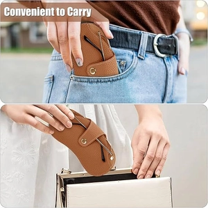 Brown lychee leather glasses pouch showing portability in pocket and handbag use