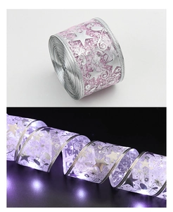 Detail of purple LED ribbon with silver stars and musical notes for Christmas decor