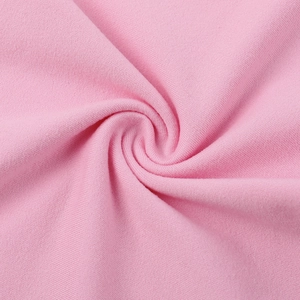 Macro shot of pink knitted fabric detail showing soft texture and premium ribbed structure