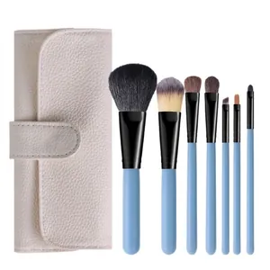 7-piece portable makeup brush set with sky blue handles and beige storage pouch