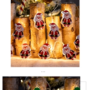 Macro view of Santa Claus shaped LED string lights illuminating a birch wood stump