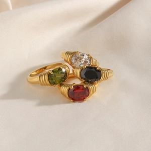 Vintage 18K gold-plated titanium rings with colorful gemstones on silk background