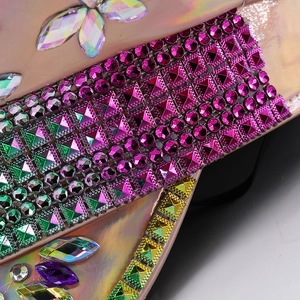 Detailed macro view of vibrant colorful rhinestones on a sparkling champagne party hat