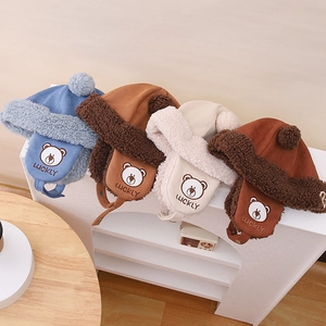 Detail showing plush fleece lining and cute bear embroidery on winter toddler earflap hats