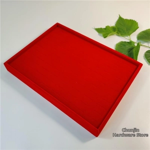 Detailed view of red velvet 100-slot jewelry display tray for rings and earrings
