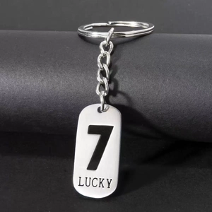 Detail of silver stainless steel keychain featuring Lucky 7 engraving and polished metal ring