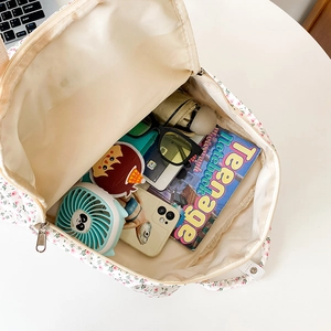 Detailed interior view of floral backpack showing large capacity for books and daily items