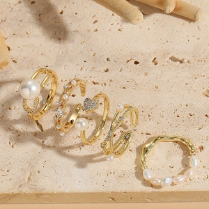 Macro shot of French retro 14K gold plated rings with freshwater pearls and zircon details