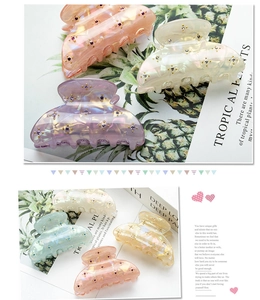 Detailed view of large PVC hair claws with sparkling rhinestones in assorted colors