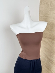 Detail of high-elasticity brown tube top with knitted texture on white mannequin
