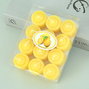 Detailed view of 12-pack lemon scented yellow tealight candles in clear box packaging