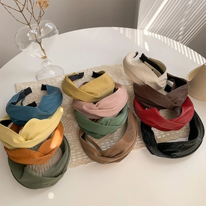 Collection of colorful faux leather criss-cross headbands with soft textured finish